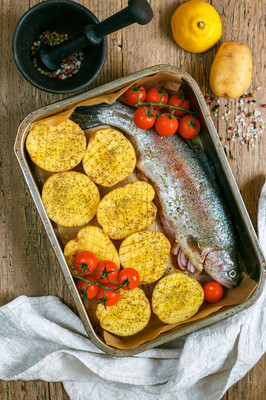 raw salmon (trout) is ready for baking with vegetables-potatoes